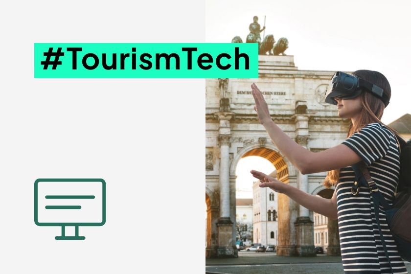 A woman wearing VR goggles is standing in front of a historic archway next to the hashtag #TourismTech and a monitor icon.