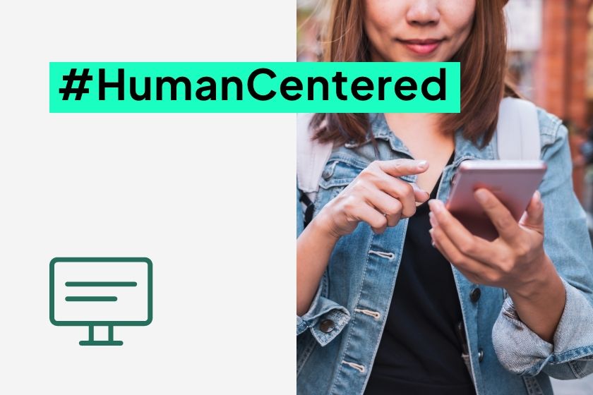 A close-up of a person wearing a denim jacket and using a smartphone, next to the hashtag #HumanCentered and a monitor icon.