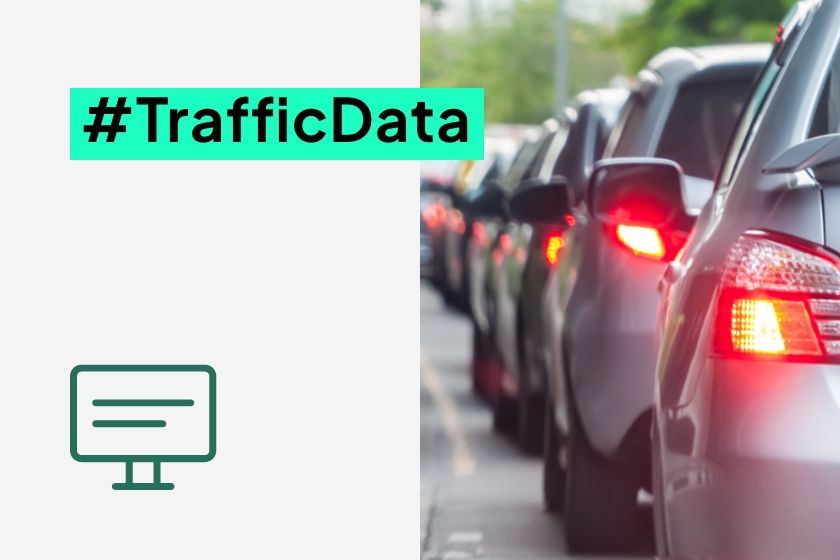 A long line of cars in a traffic jam next to the hashtag #TrafficData and a monitor icon.